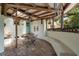 Cozy outdoor patio with brick flooring, wooden beams, a ceiling fan, a seating area and a fountain at 604 Cherokee Dr, Orlando, FL 32801