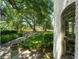 Lush greenery and mature trees surround this home, with a glimpse of a park through the arched window at 604 Cherokee Dr, Orlando, FL 32801