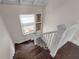 Wooden staircase with white railing, window, and artwork on the wall, adding character to this home's design at 604 Cherokee Dr, Orlando, FL 32801