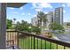 Balcony view of green lawn, lush trees and other buildings at 6165 Carrier Dr # 1304, Orlando, FL 32819