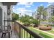 Relax on the balcony overlooking lush grounds, pool, and city skyline at 6165 Carrier Dr # 1304, Orlando, FL 32819