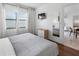 Serene bedroom with a large window, TV, dresser, and a view into an adjoining room at 6165 Carrier Dr # 1304, Orlando, FL 32819