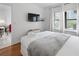 Comfortable bedroom with a flat-screen TV, dresser, and a view into the living room at 6165 Carrier Dr # 1304, Orlando, FL 32819