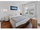 Comfortable bedroom featuring a plush bed and an art piece on the wall, illuminated by sconces at 6165 Carrier Dr # 1304, Orlando, FL 32819