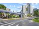 Exterior of tall condominium building with covered entrance at 6165 Carrier Dr # 1304, Orlando, FL 32819