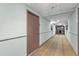 Hallway with neutral decor leading to the unit's entrance at 6165 Carrier Dr # 1304, Orlando, FL 32819