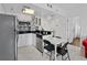 Well-equipped kitchen featuring white cabinets and mosaic backsplash at 6165 Carrier Dr # 1304, Orlando, FL 32819