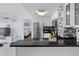 Compact kitchen with stainless steel appliances and black countertops at 6165 Carrier Dr # 1304, Orlando, FL 32819