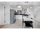 Bright kitchen with stainless steel appliances, white cabinets, and black countertop and a seating area with a table at 6165 Carrier Dr # 1304, Orlando, FL 32819