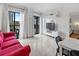 Inviting living room featuring a red couch, balcony access, and modern decor at 6165 Carrier Dr # 1304, Orlando, FL 32819
