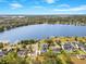 Aerial view of an upscale neighborhood, showing lakefront homes, mature trees, and a large lake at 705 N Lake Sybelia Dr, Maitland, FL 32751