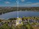 Aerial view of a luxury waterfront property with a pool, solar panels, and a dock at 705 N Lake Sybelia Dr, Maitland, FL 32751