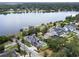 Stunning aerial view of a waterfront property with solar panels, a pool, and private dock at 705 N Lake Sybelia Dr, Maitland, FL 32751