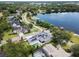 Aerial view of a residential neighborhood with lakeside access, featuring houses with pools and docks at 705 N Lake Sybelia Dr, Maitland, FL 32751