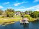 Stunning aerial view of a contemporary home on a waterfront property, complete with a private dock and boat lift at 705 N Lake Sybelia Dr, Maitland, FL 32751