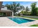 Beautiful backyard featuring a pool with pavers, and a modern home with large trees at 705 N Lake Sybelia Dr, Maitland, FL 32751