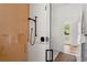Stylish bathroom with a glass-enclosed shower featuring vibrant tiles and matte black fixtures at 705 N Lake Sybelia Dr, Maitland, FL 32751