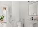 Well-lit bathroom featuring a pedestal sink, toilet, and glass shower, all in bright white at 705 N Lake Sybelia Dr, Maitland, FL 32751