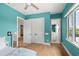 Bright blue bedroom with walk-in closet and a view of a bathroom at 705 N Lake Sybelia Dr, Maitland, FL 32751
