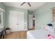 Calm bedroom features neutral paint, hardwood floors, double door closet and a large window at 705 N Lake Sybelia Dr, Maitland, FL 32751