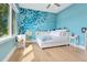 Inviting blue bedroom with whimsical mural and a scenic outdoor view at 705 N Lake Sybelia Dr, Maitland, FL 32751