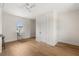 Bright bedroom featuring wood floors, an open window with a sink, and a modern ceiling fan at 705 N Lake Sybelia Dr, Maitland, FL 32751