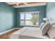 Airy bedroom with teal walls, and large window offering a view of the lake at 705 N Lake Sybelia Dr, Maitland, FL 32751