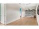 Versatile bonus room with hardwood floors, built-in shelving, and access to another room at 705 N Lake Sybelia Dr, Maitland, FL 32751