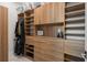 Walk-in closet with custom wood organizers, drawers, shelves, and ample hanging space at 705 N Lake Sybelia Dr, Maitland, FL 32751