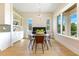 Bright dining area features modern light fixture, light walls, and a piano at 705 N Lake Sybelia Dr, Maitland, FL 32751