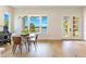 Elegant dining area with scenic water views and modern lighting fixtures at 705 N Lake Sybelia Dr, Maitland, FL 32751