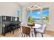 Elegant dining area with a piano, bathed in natural light with views of the lake at 705 N Lake Sybelia Dr, Maitland, FL 32751