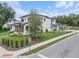 Striking home exterior with lush lawn, complemented by a detached garage and mature landscaping at 705 N Lake Sybelia Dr, Maitland, FL 32751