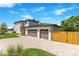 Modern home featuring a three-car garage, paver driveway, beautiful landscaping, and solar panels for energy efficiency at 705 N Lake Sybelia Dr, Maitland, FL 32751