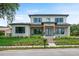 Beautifully landscaped contemporary two-story home with a manicured lawn and inviting front entrance at 705 N Lake Sybelia Dr, Maitland, FL 32751