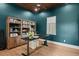 A beautifully designed home office boasts custom wood ceilings and a stylish adjustable height desk at 705 N Lake Sybelia Dr, Maitland, FL 32751