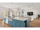 Island kitchen with modern appliances, farmhouse sink, and open layout to the living area at 705 N Lake Sybelia Dr, Maitland, FL 32751
