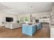 Open-concept kitchen featuring stainless steel appliances, a center island, and seamless flow to living area at 705 N Lake Sybelia Dr, Maitland, FL 32751
