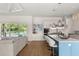 Open-concept kitchen with stainless appliances, a large island, and seamless flow to living area and pool at 705 N Lake Sybelia Dr, Maitland, FL 32751