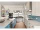 Gourmet kitchen boasts stainless steel appliances, a large island, and stylish pendant lighting at 705 N Lake Sybelia Dr, Maitland, FL 32751