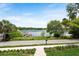 Picturesque lake view from the property, featuring a private dock and lush landscaping at 705 N Lake Sybelia Dr, Maitland, FL 32751