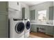 Contemporary laundry room with modern washer and dryer units and ample counter space at 705 N Lake Sybelia Dr, Maitland, FL 32751