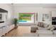 Bright living room with sliding doors leading to the pool, with a large sectional sofa at 705 N Lake Sybelia Dr, Maitland, FL 32751