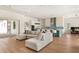 Bright open-plan living room with view of the kitchen featuring an island with seating at 705 N Lake Sybelia Dr, Maitland, FL 32751