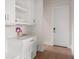 Bright mudroom with white cabinets, counter space, and a convenient bench near the exterior door at 705 N Lake Sybelia Dr, Maitland, FL 32751