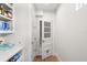 Bright pantry with white shelving units and organized storage space at 705 N Lake Sybelia Dr, Maitland, FL 32751