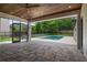 Beautiful outdoor patio featuring wood ceilings, a ceiling fan, and a clear view of the pool at 705 N Lake Sybelia Dr, Maitland, FL 32751
