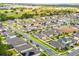 View of a residential neighborhood that is surrounded by green landscapes, lakes, and local road networks at 714 Golden Elm Dr, Apopka, FL 32703