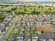 A vibrant neighborhood is shown with lush landscaping and views of the community golf course and recreational areas at 714 Golden Elm Dr, Apopka, FL 32703