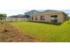 Expansive backyard with healthy lawn and privacy fence, perfect for outdoor activities and relaxation at 714 Golden Elm Dr, Apopka, FL 32703